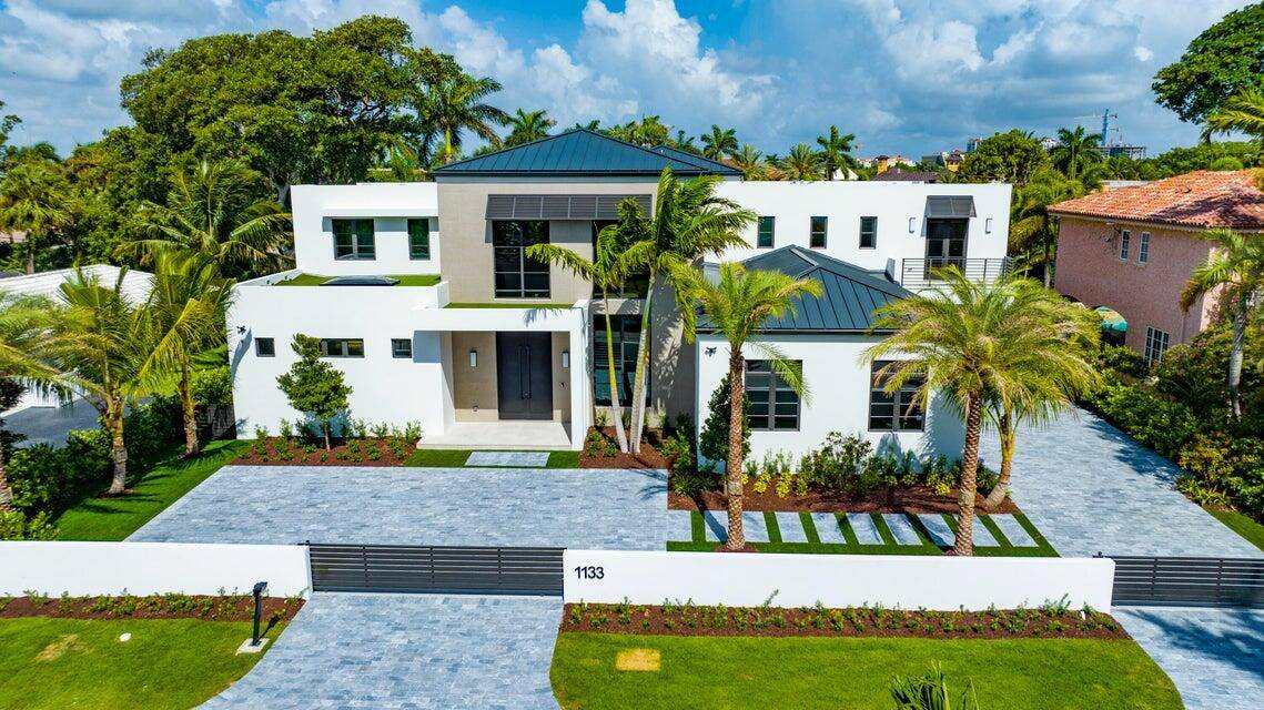 Commanding a grand sense of arrival, two gated entries, leading into a paver courtyard and a seperate driveway to a side load three car garage, introduce this chic 'Farmhouse Modern' ...