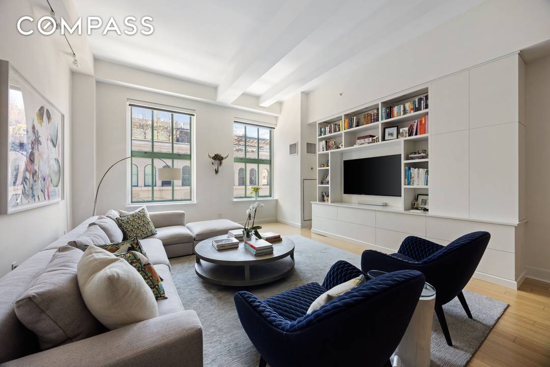 Currently configured as a three bedroom, this loft style residence offers a flexible and well proportioned layout complemented by 12 foot beamed ceilings and oversized rooms throughout.