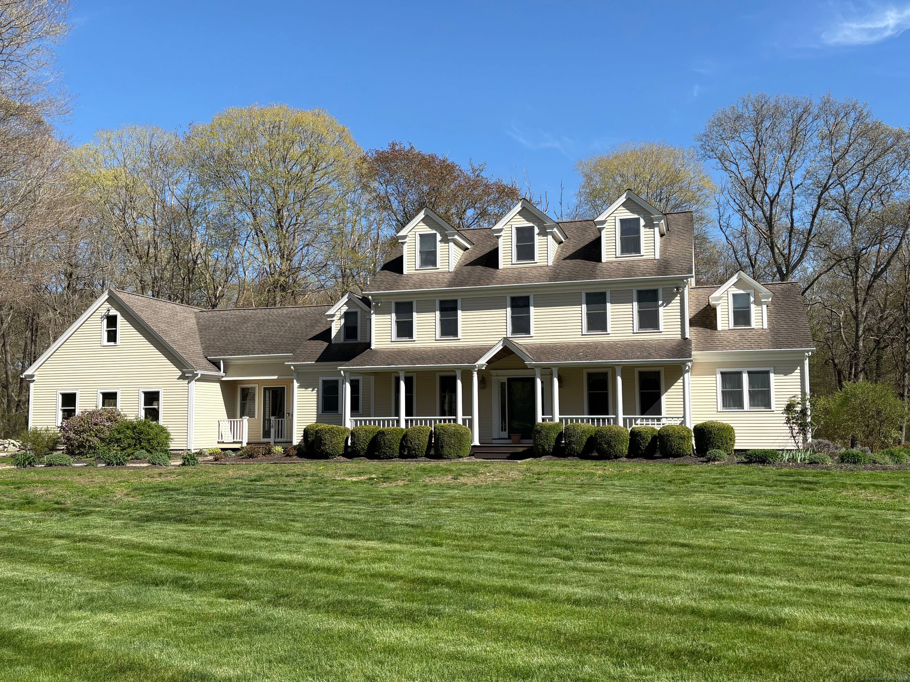 Welcome to this classic New England Colonial home offering a truly fabulous location with privacy yet convenience.