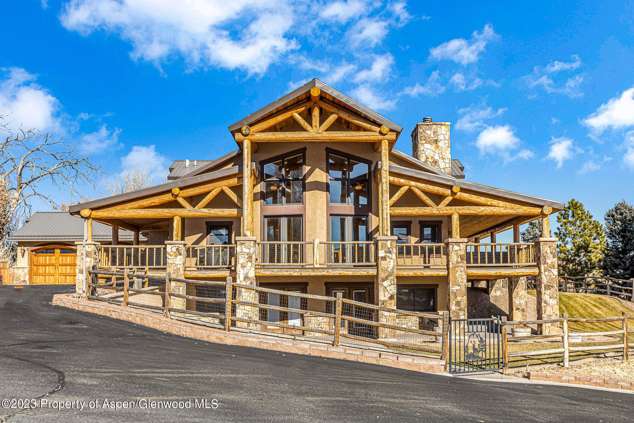Presenting a captivating Rifle property showcasing a custom designed 3 story log home, along with a 2 bedroom guest house with a 4 car garage, and a heated shop, blending ...