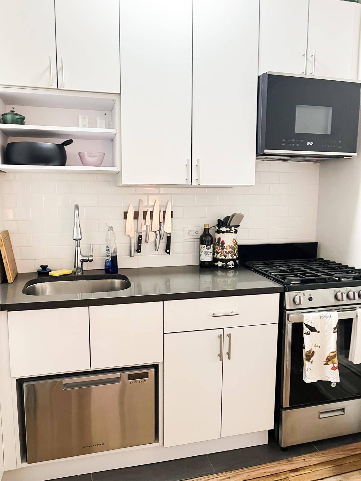 Newly renovated 2BR in an elevator building with open kitchen equipped with stainless steel appliances including dishwasher.