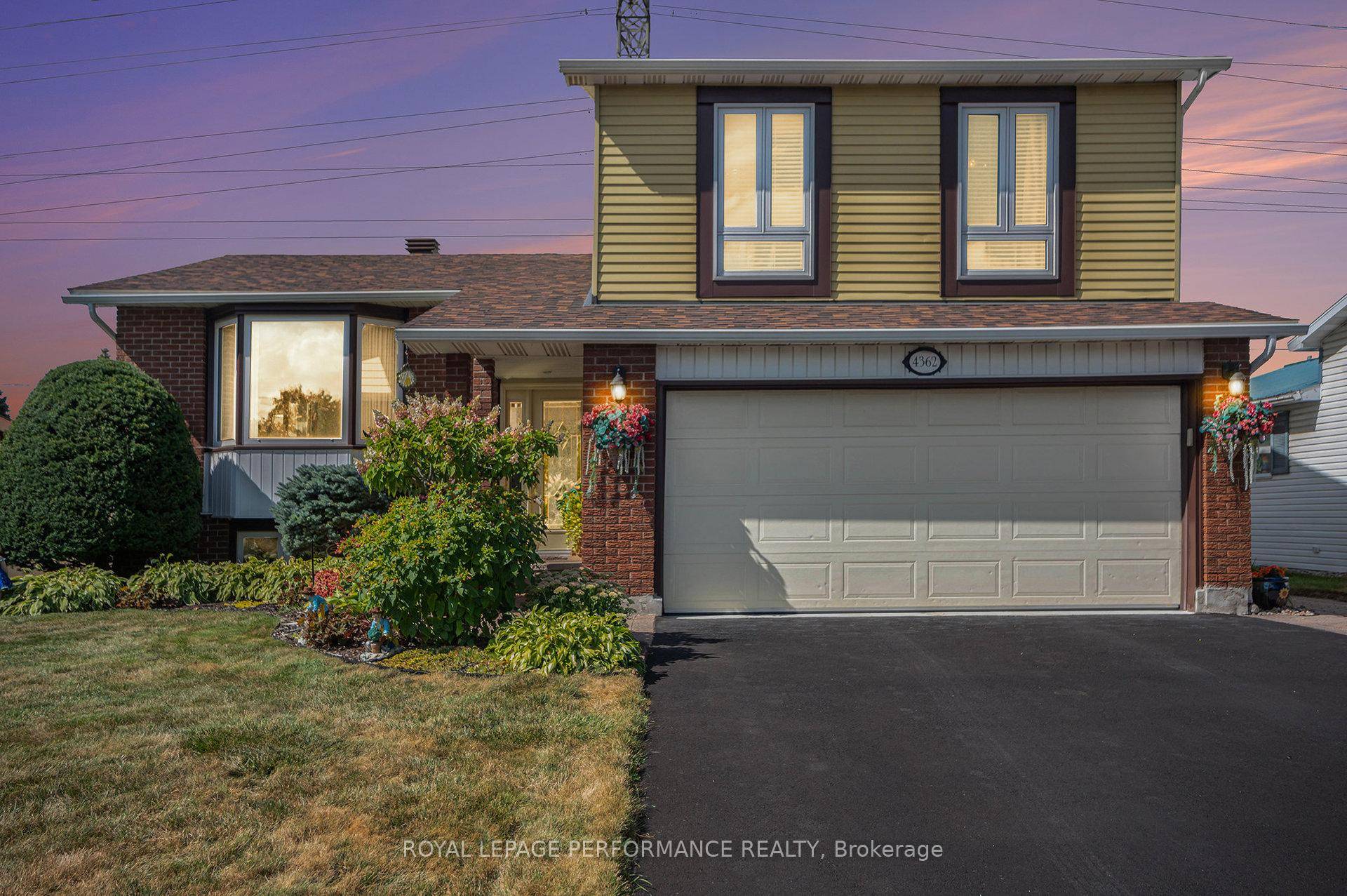 Beautiful Side Split Level in Pineview backing on walking trails with an inground heated pool surrounded by a stunning landscaped and well maintained yard.