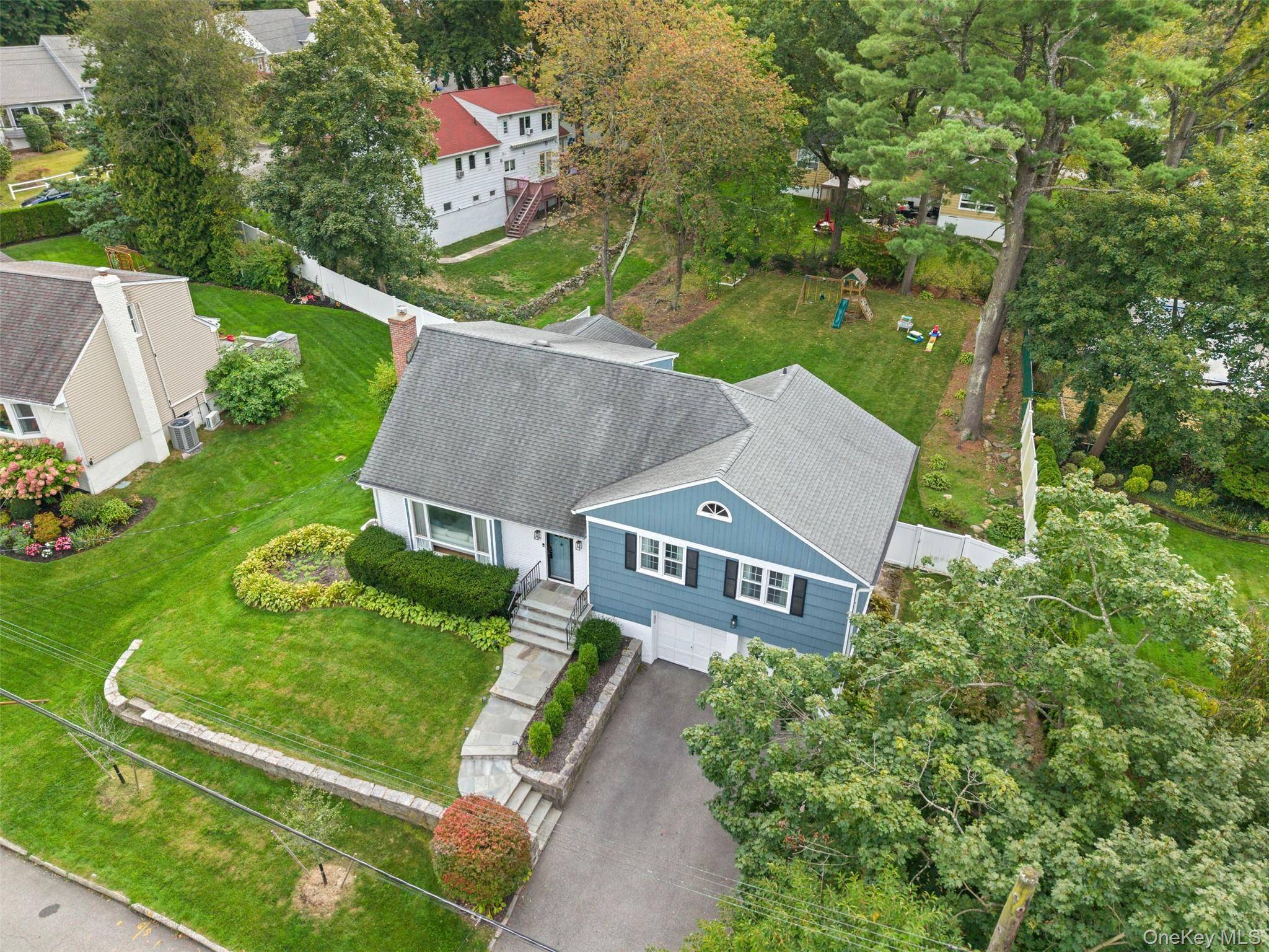 Welcome to this spacious and thoughtfully designed split level home in New Rochelle s sought after North End, offering modern upgrades and a rare for the neighborhood oversized flat backyard.