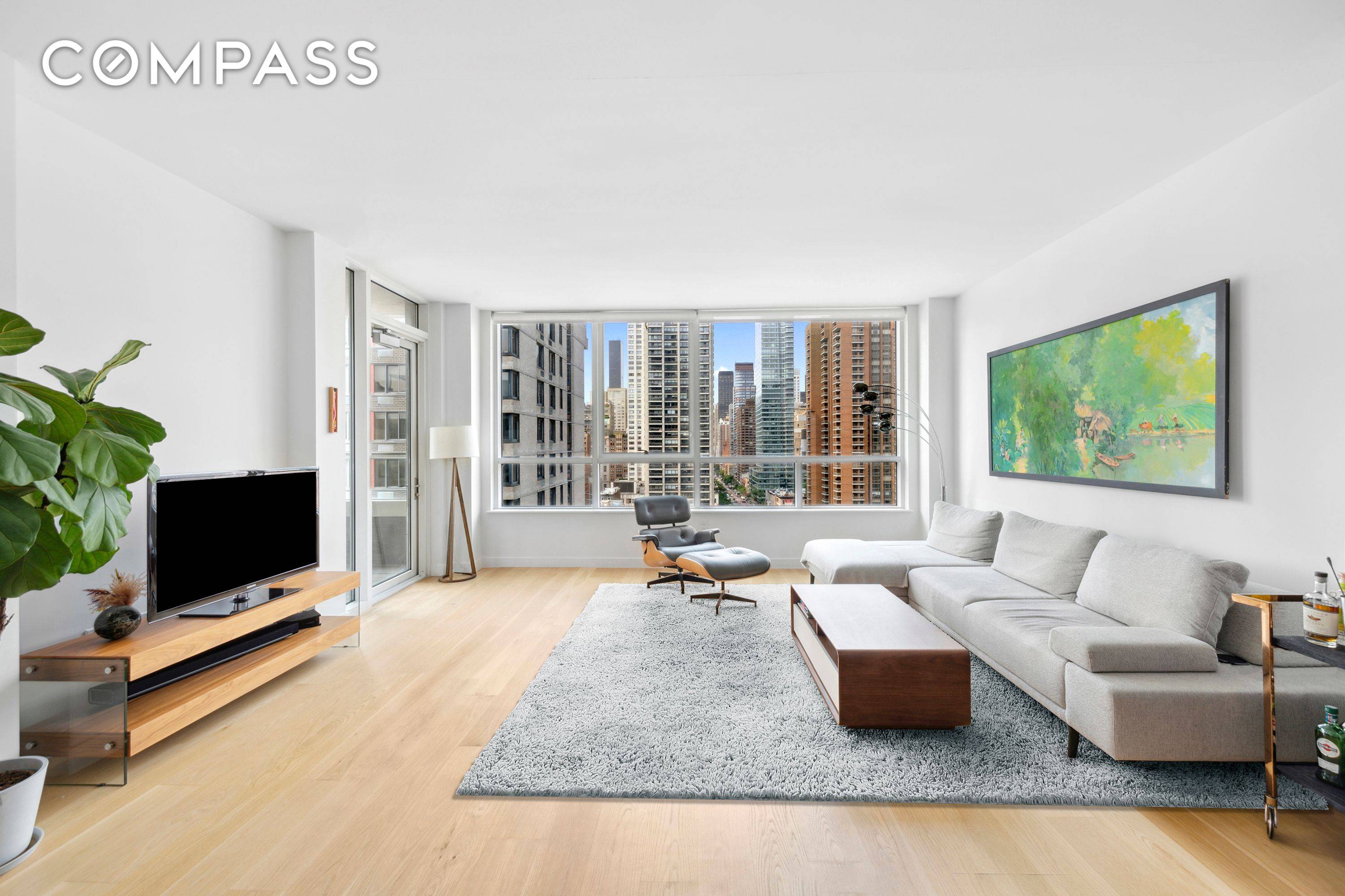 Step into this bright and airy residence, where floor to ceiling windows and a private terrace showcase sweeping open city views, bathing every room in golden southern light.