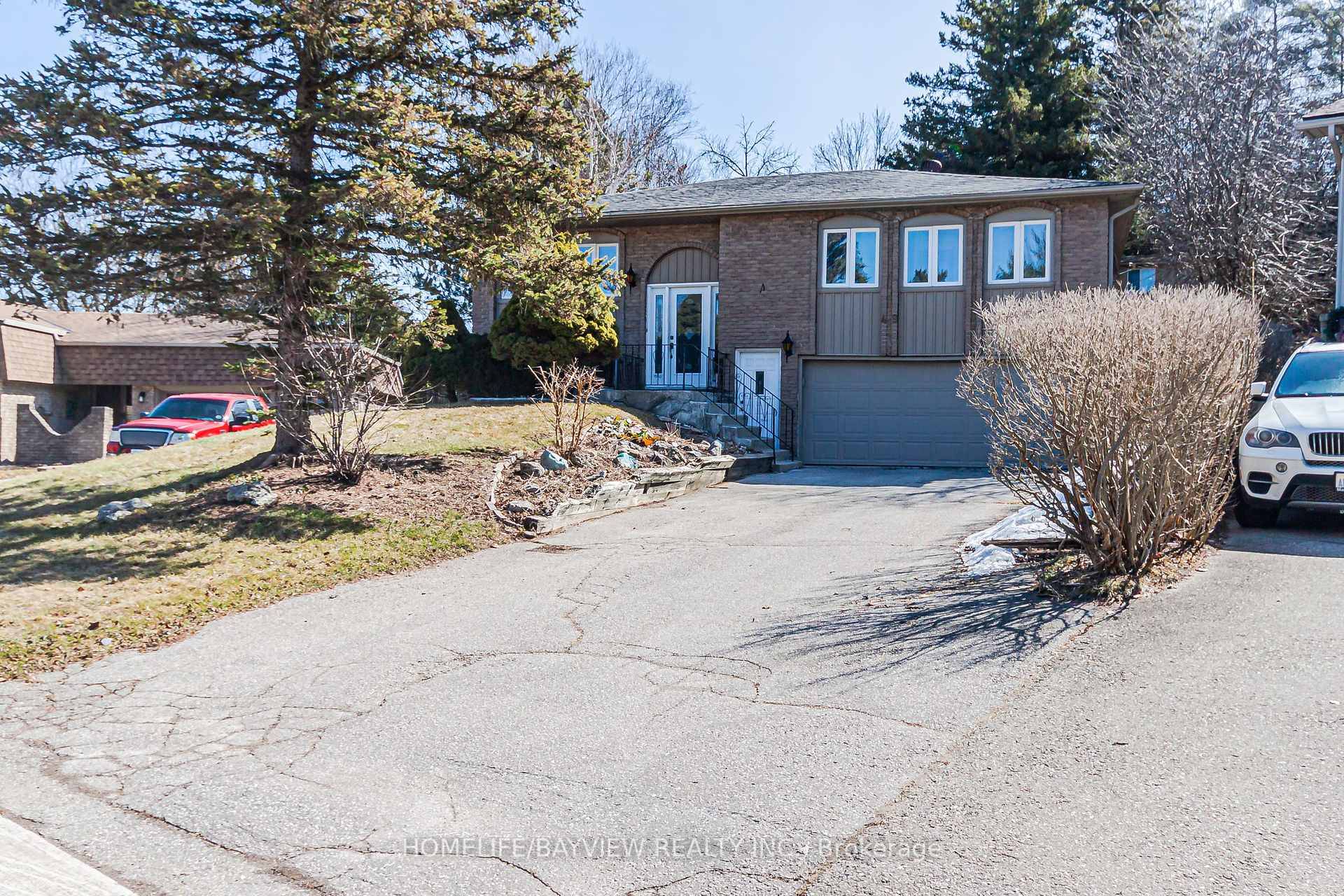 Good Opportunity Raised Bungalow on a quiet cul de sac with an oversized pie shaped lot and a private, forest like backyard.