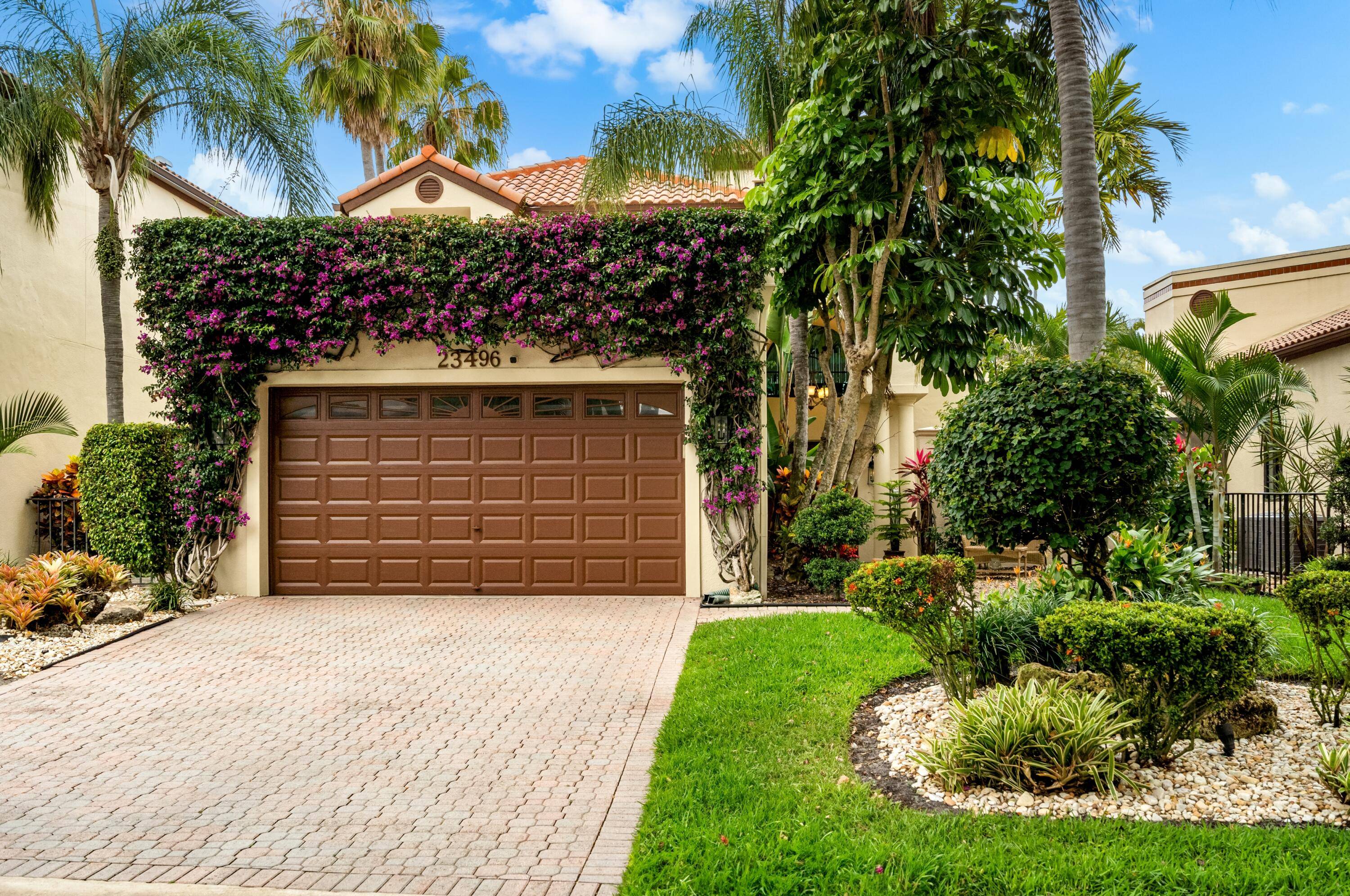 Beautifully landscaped with mature palms and tropical plants, this recently updated residence, in prestigious Boca Pointe's Valencia enclave, is elegantly appointed with high volume ceilings, Venetian plaster finishes, unique windows, ...