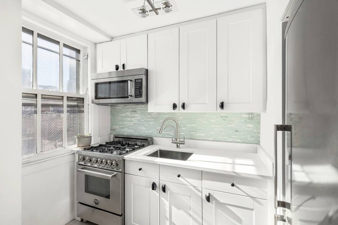 Residence 9B is a bright, high floor corner one bedroom featuring a beautifully renovated kitchen and an airy, sun filled layout with open city views.