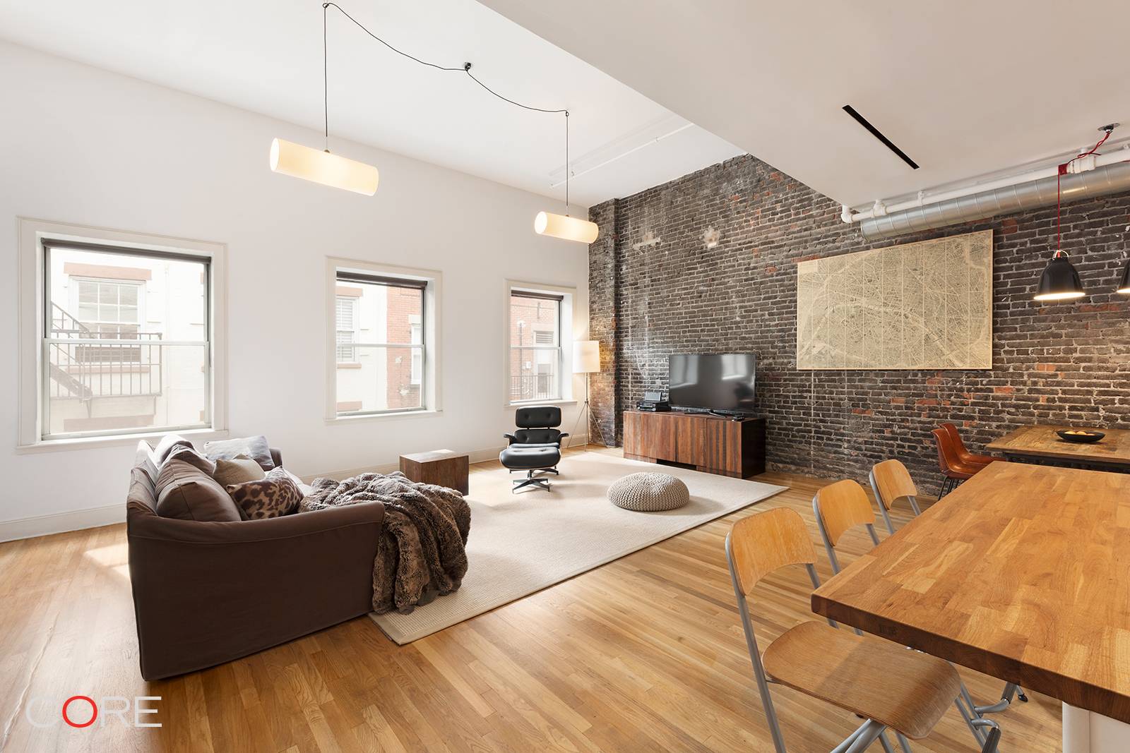 Authentic south facing duplex loft in the heart of Tribeca s historic district with soaring ceilings and oversized windows.