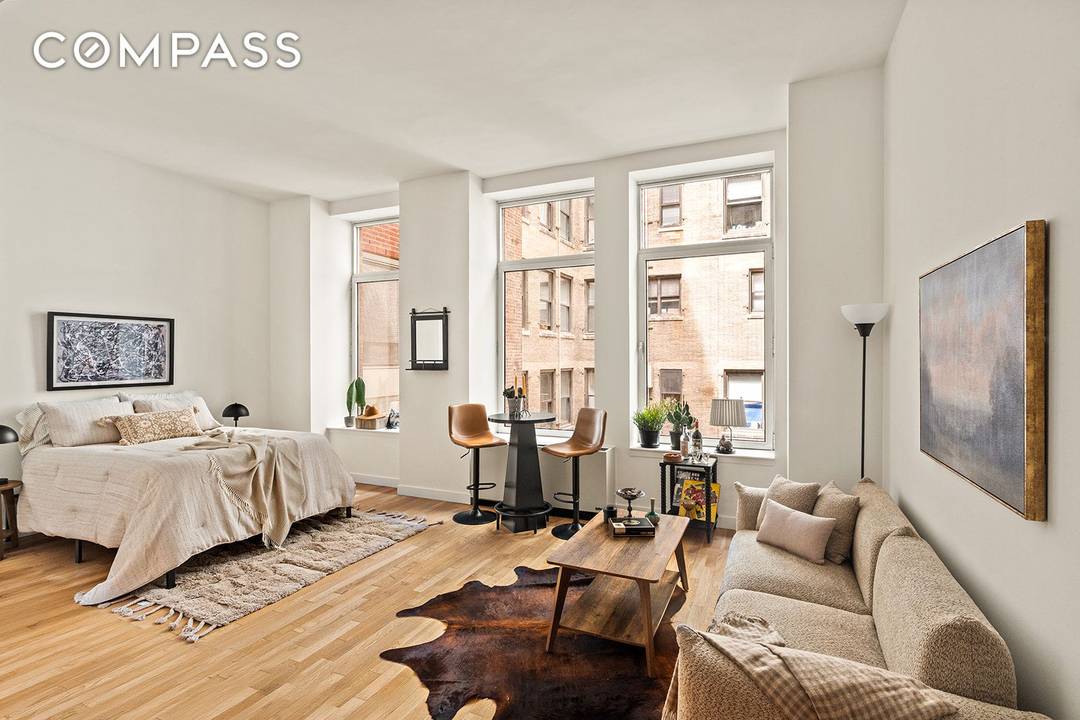 Spacious Alcove Studio with In Unit Washer Dryer in the Heart of FiDi Residence 7G is a thoughtfully designed alcove studio offering distinct spaces for living, dining, and sleeping.
