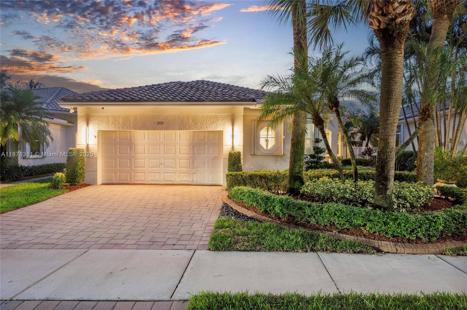 Beautiful lakefront home in Bay Pointe at gated Weston Hills.