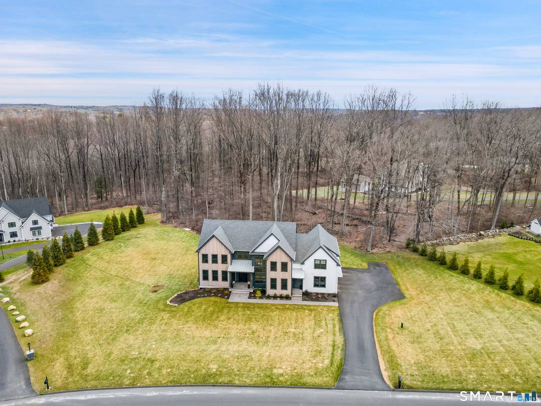 Privately set within an enclave of newer luxury homes on a serene cul de sac, this exceptional residence offers a refined blend of architectural elegance and modern comfort.