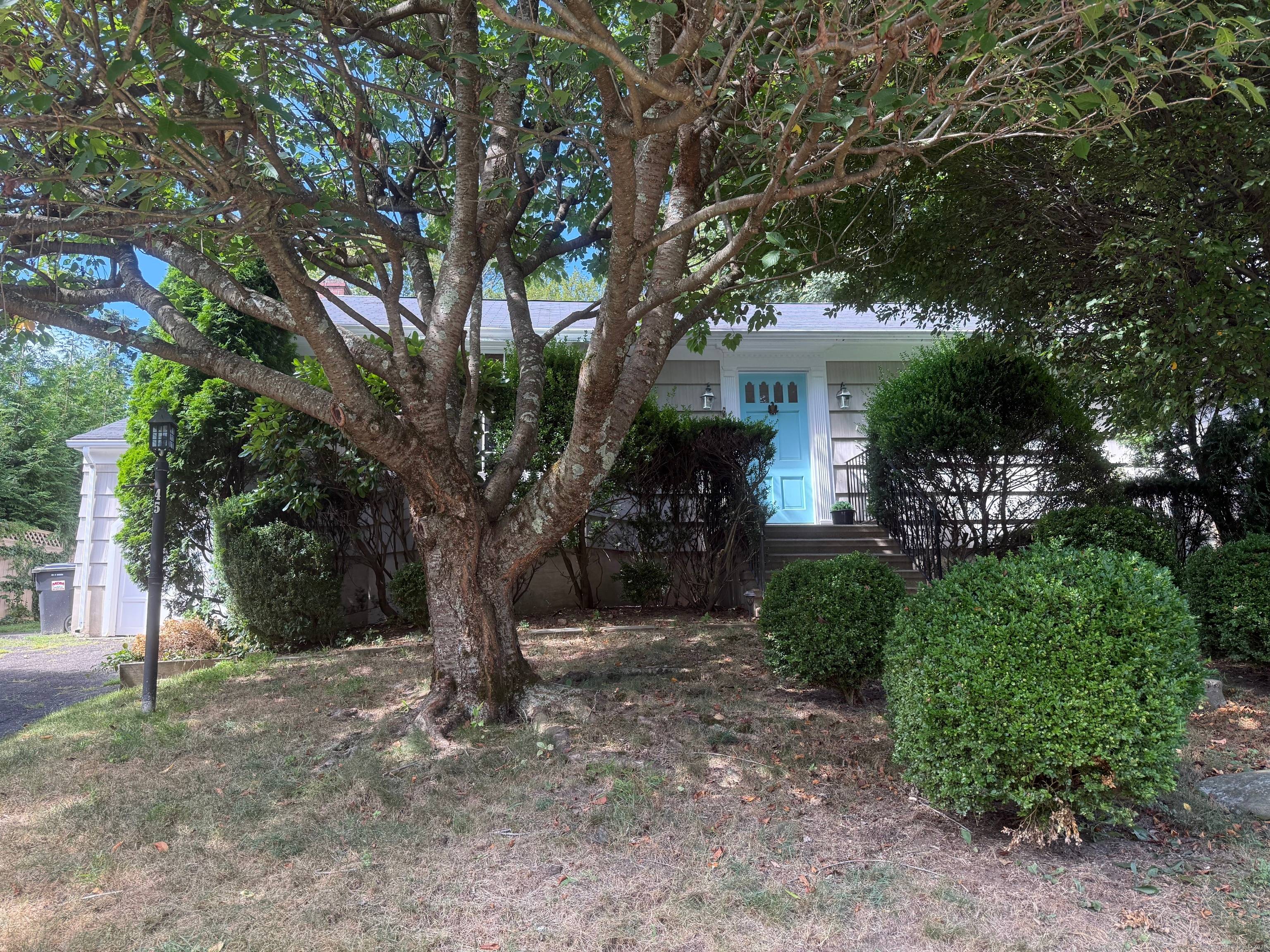 Experience the best of in town living in this bright and inviting ranch, tucked among the trees in one of New Canaan's most sought after neighborhoods.