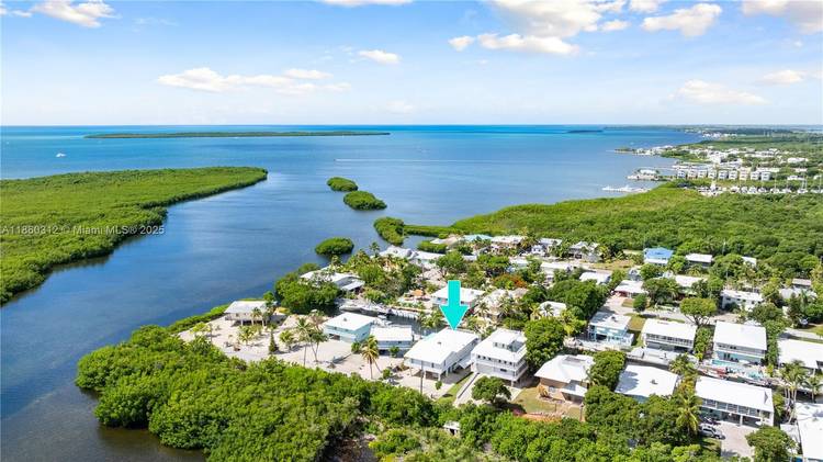 Waterfront Key Largo Retreat This is an exceptional all CBS constructed home, featuring a concrete roof that enhances durability and peace of mind, offering direct ocean access and putting world ...