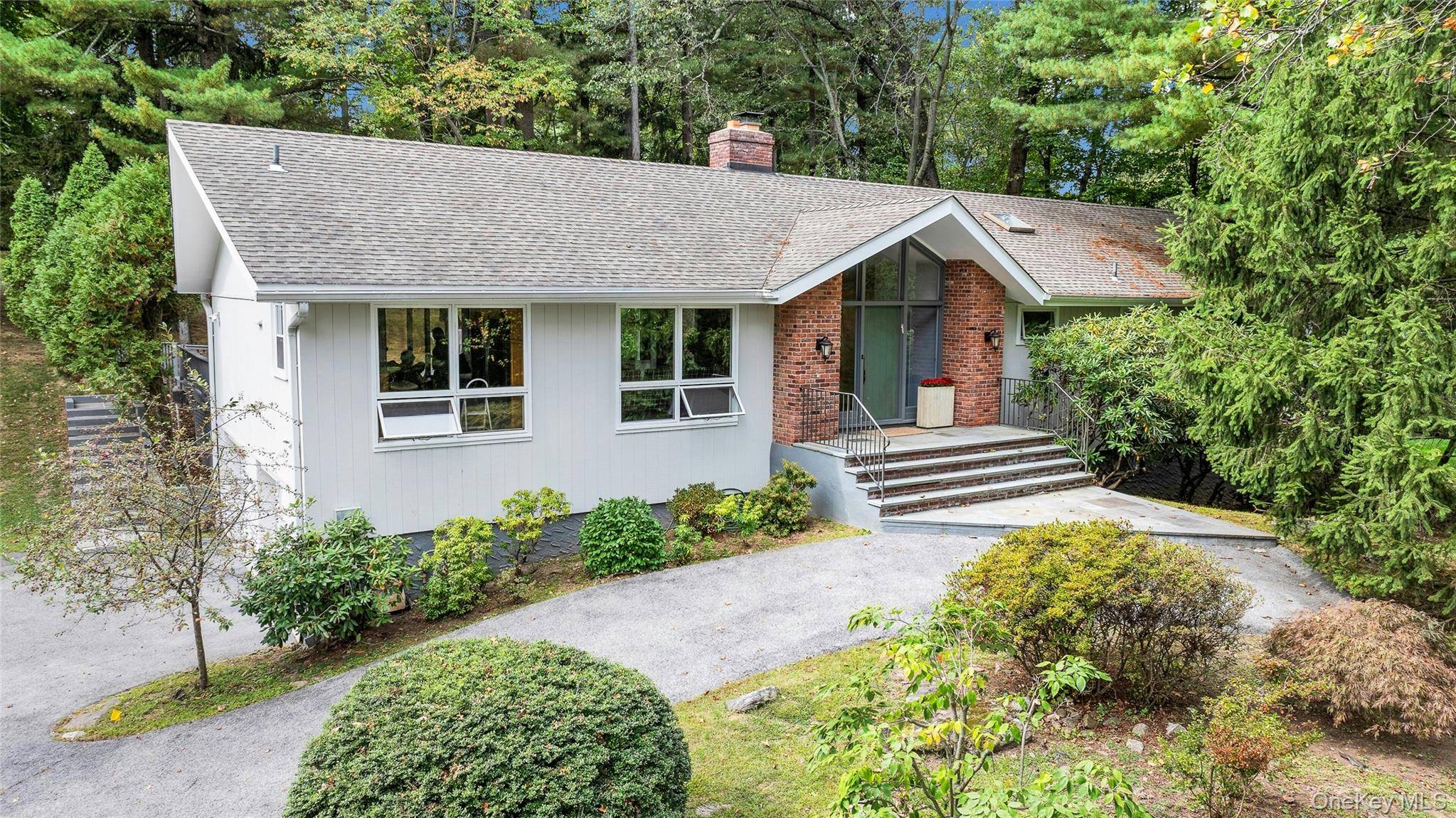 SPORT COURT currently a Tennis Court, PRIVACY, BYRAM HILLS ARMONK SCHOOLS, Many Walls of Glass, 3 Bedrooms on Main Level, 2 Bedrooms or Offices on Lower Level.