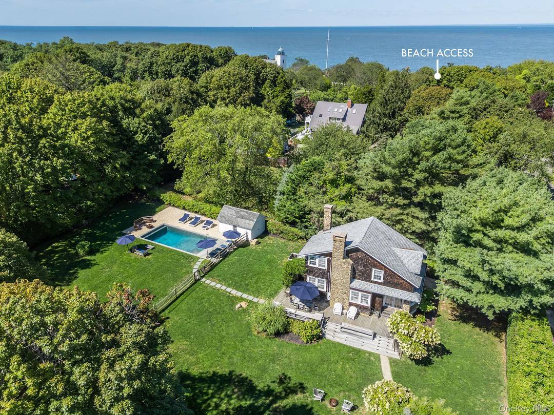 A timeless 1927 shingled cottage set amid lush, established gardens just moments from Horton Point Lighthouse and the Long Island Sound, with a beach at the end of the road.