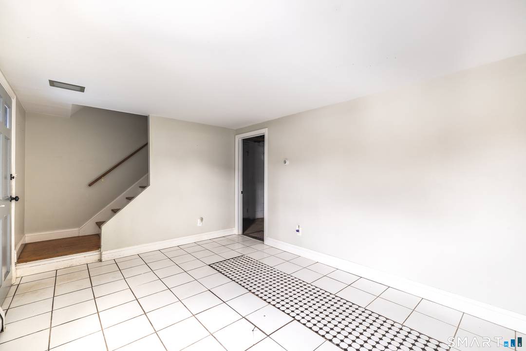 Located in the North End of Bridgeport, this Cape Cod style home offers flexible living space, extensive garage options, and convenient access to everyday amenities.