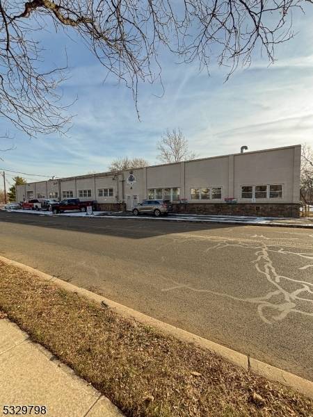 This commercial property features a large freestanding building with high ceilings and updated offices, providing a modern and spacious work environment.