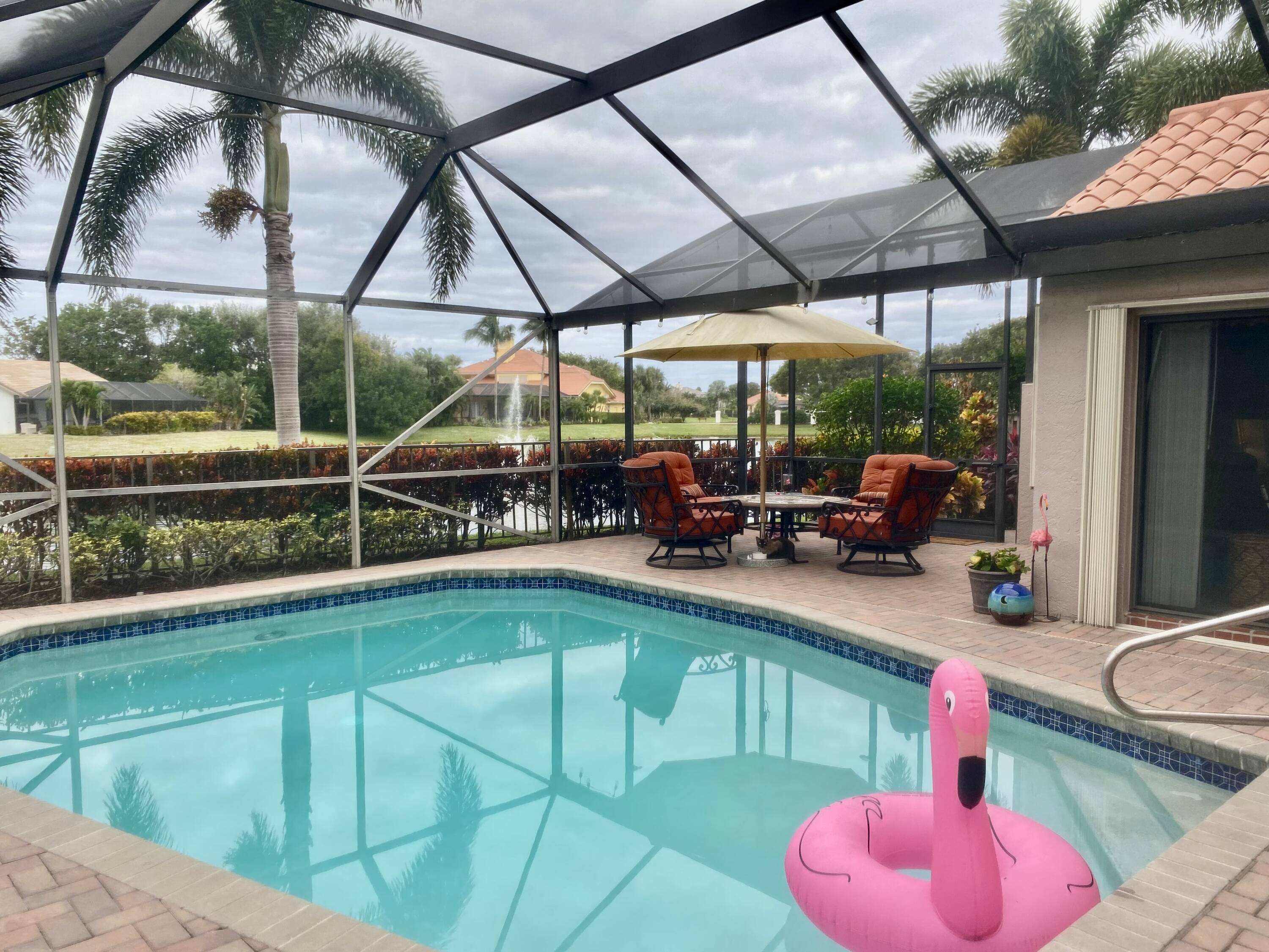 Beautiful, sunny, updated 3BR 2BA ranch with private pool and water views in gated manned community in coveted Palm Beach Gardens.