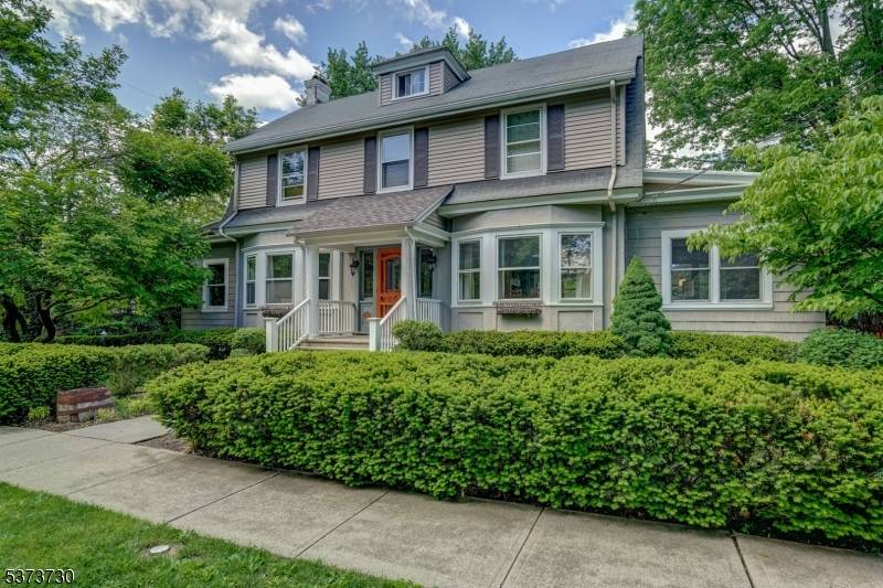Beautifully preserved and thoughtfully updated 1910 Colonial featuring 4 spacious bedrooms and 3.