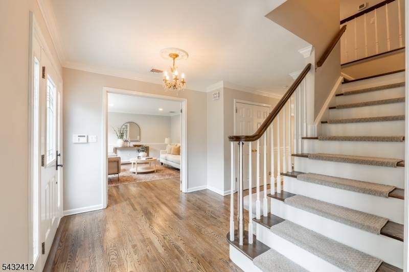Nestled on a peaceful cul de sac, this beautifully updated center hall colonial offers a serene retreat with woodlands and the soothing sound of a babbling brook.