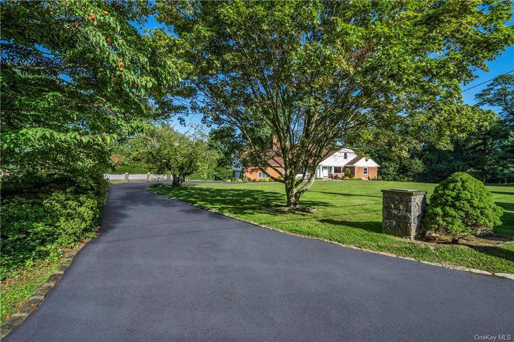 Experience luxurious living in this stunning Hartsdale estate, nestled on over an acre of beautifully landscaped grounds.