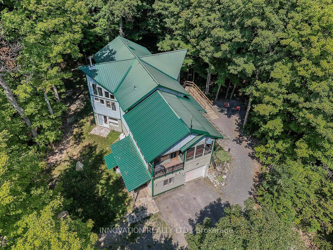 Extraordinary Three Bedroom Home with In Law Suite, Large Sunroom and a Huge Garage !
