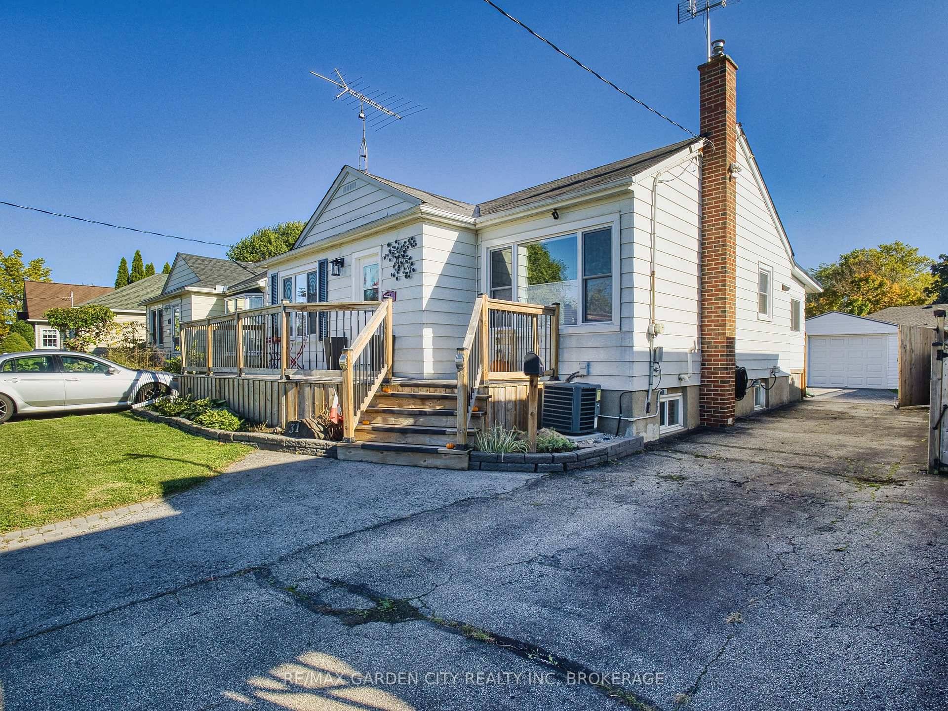 Move in ready bungalow with a large detached garage and in ground pool !