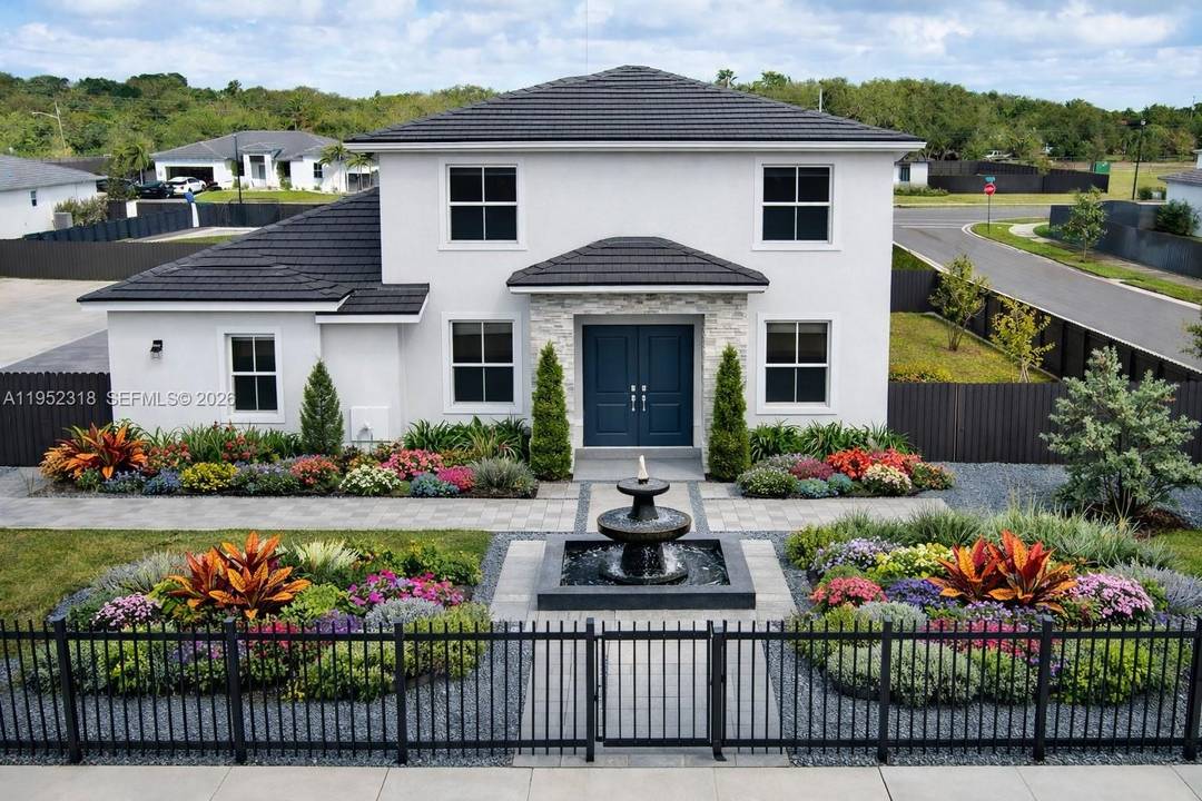 This spacious home features an open concept layout seamlessly connecting the living room, family room, dining area, and large kitchen.