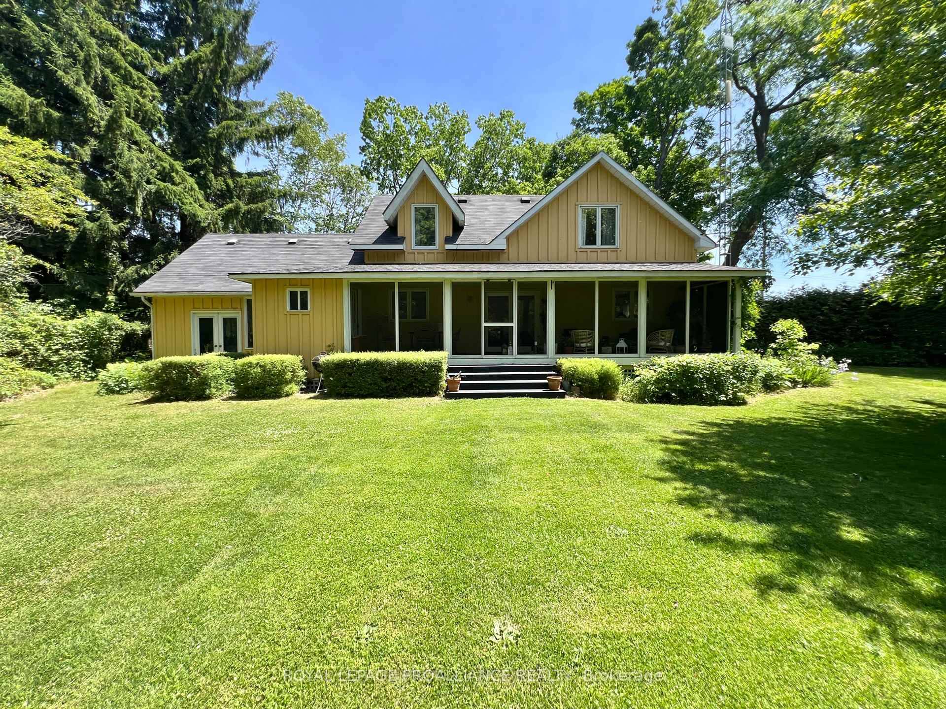 This mid century modern two storey home features an attached garage, large fire pit, and covered screen room designed for enjoying the sights and sounds of your own private forest.