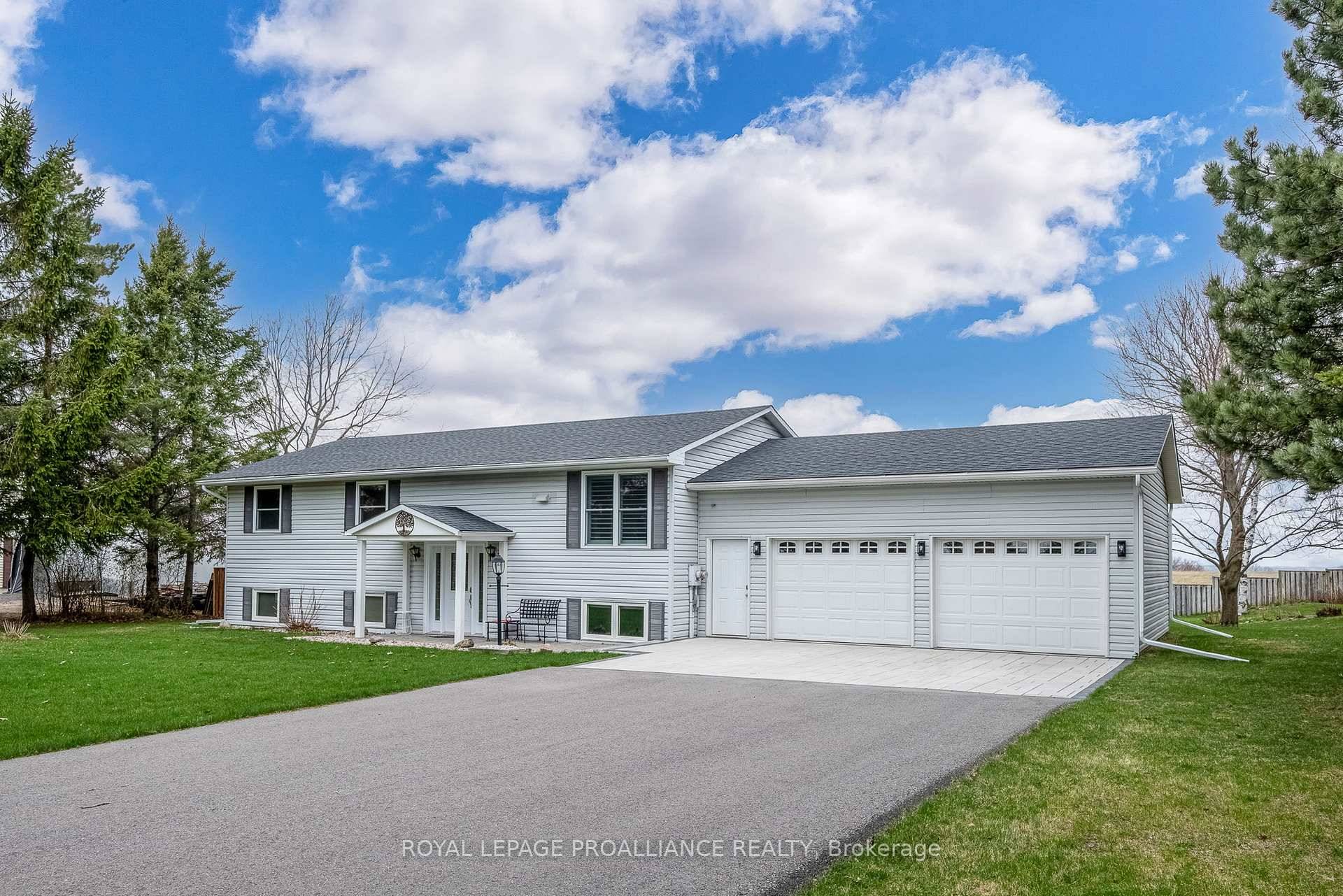 Nestled on a picturesque acre lot, this beautifully maintained raised bungalow offers stunning countryside views overlooking Rice Lake.