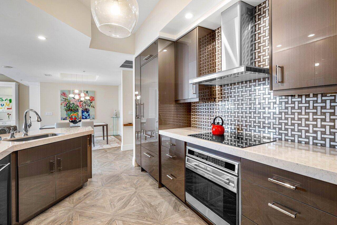 Porcelain tile plank wood flooring, Custom closets throughout, Quartz countertops 2 1 2 inch edge, Subzero Wolf appliances, wine cooler, acrylic gloss cabinets, LED plus dimmers.