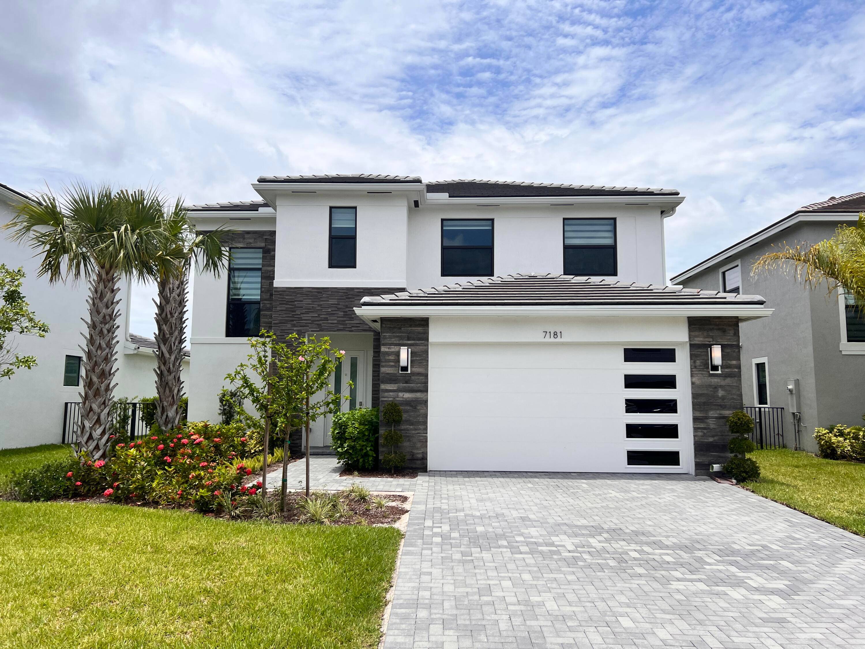 Stunning 2022 built 4Bed 3Bath 2 car garage home on the lake in gated Villamar at Toscana Isles.
