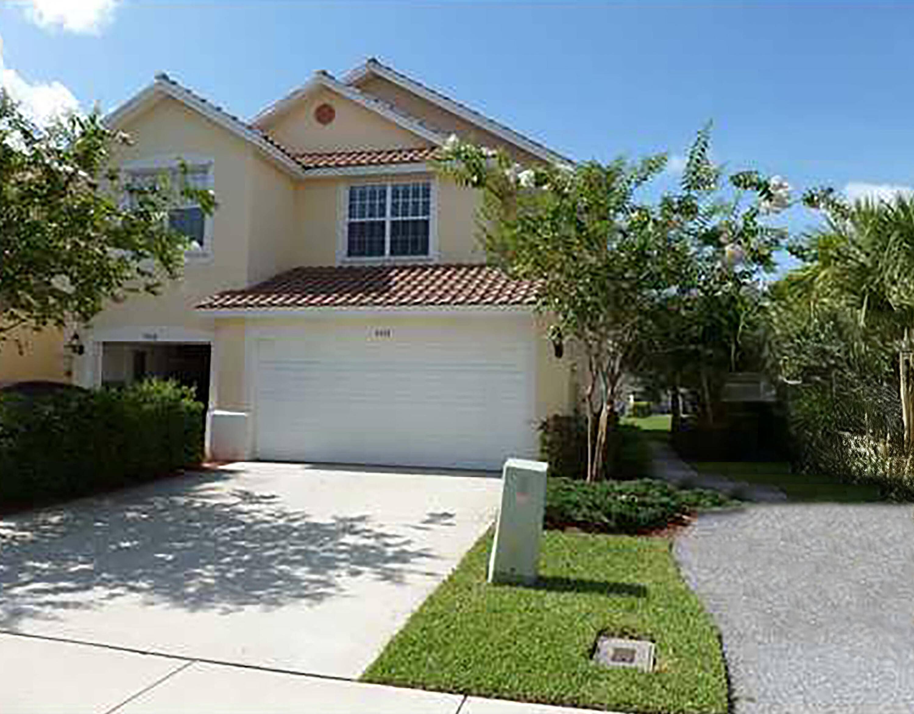 Bright and spacious corner townhome with lake views in the desirable gated community of Pinewood Lake.