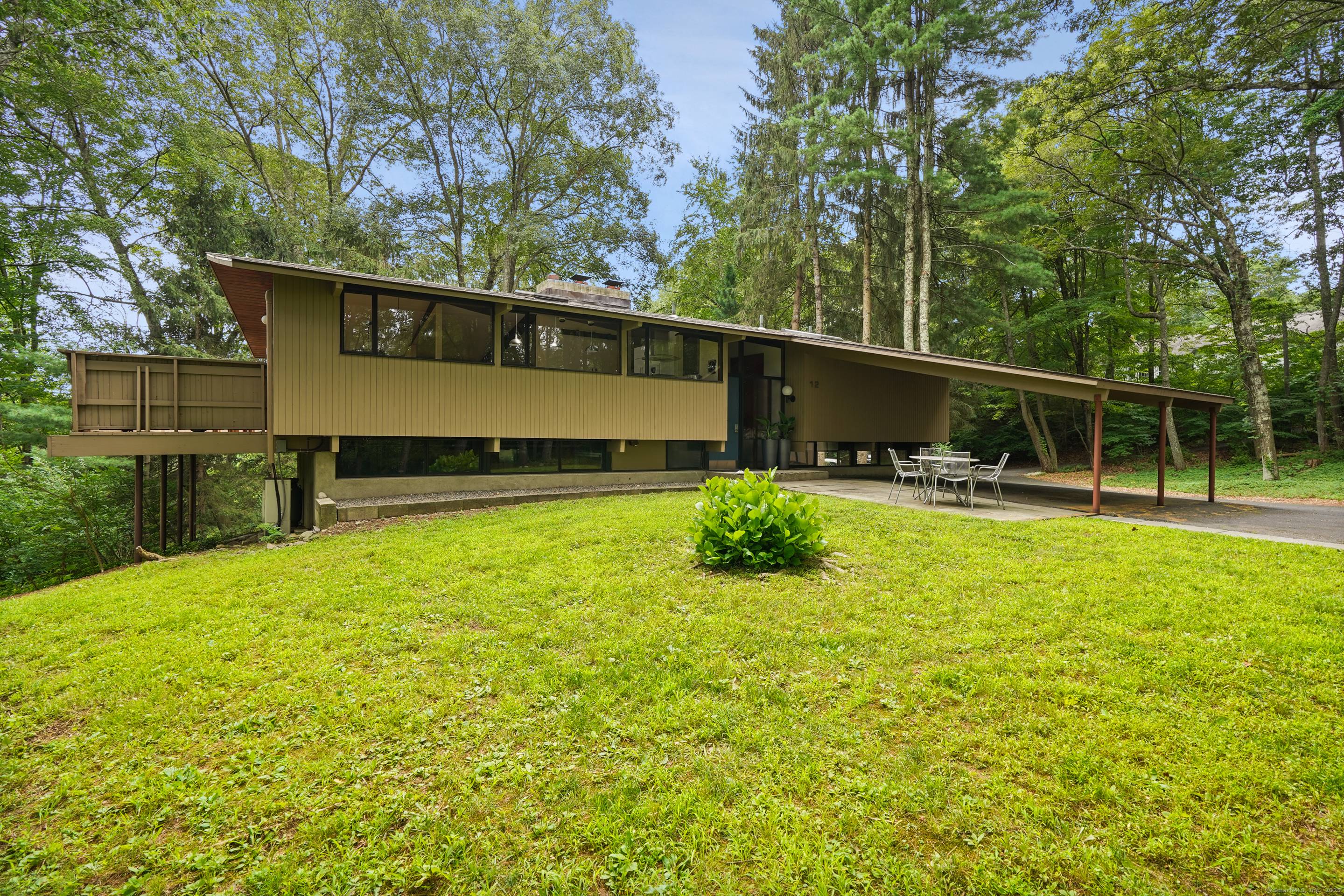 Perched atop a private hill near Georgetown Village, this striking Mid Century Modern in Wilton offers seamless indoor outdoor living, just minutes from shopping, dining, and Metro North.
