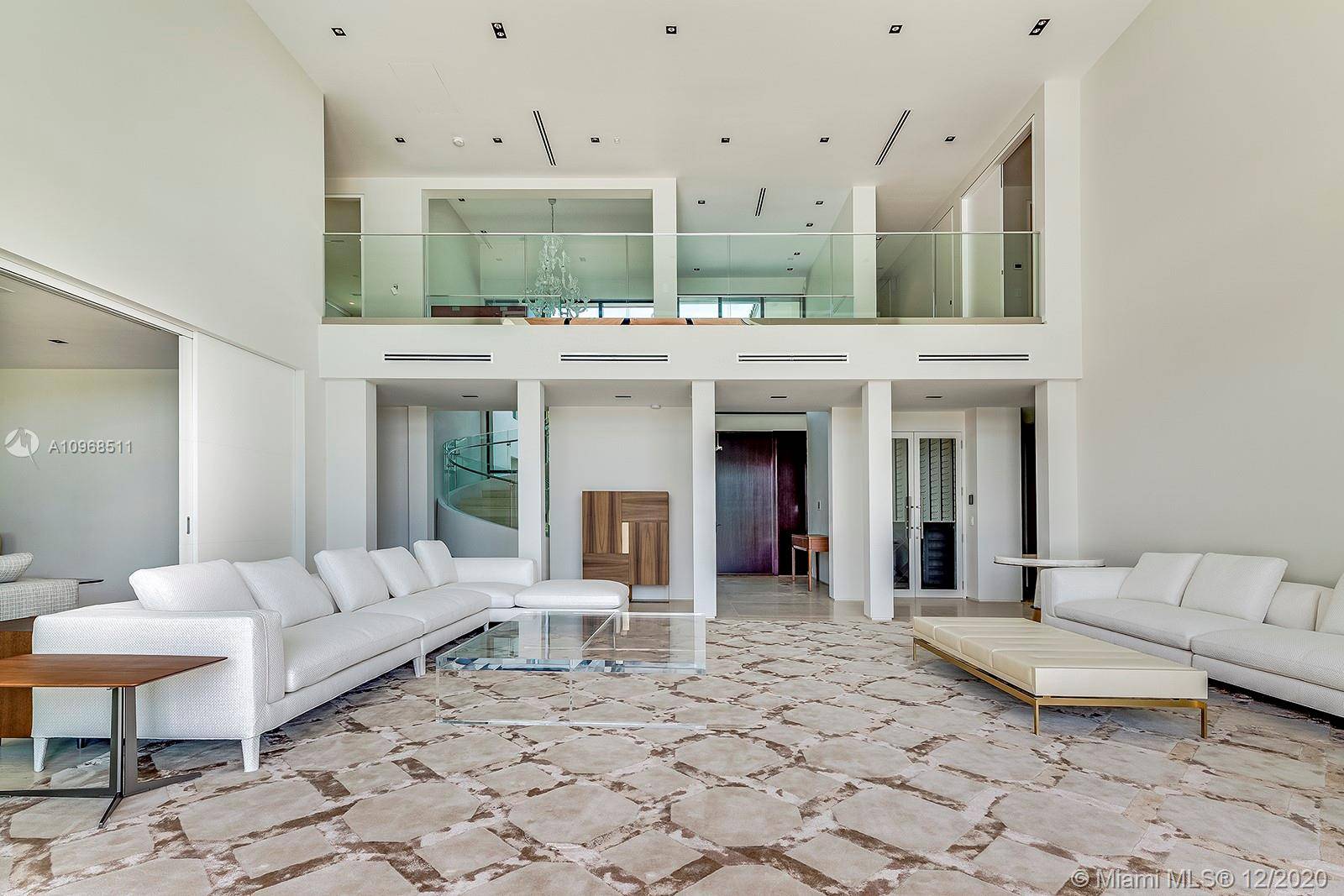 Sweeping southern wide bay water views over Indian Creek Golf Course from this stunning luxurious modern waterfront home in Bay Harbor Islands.