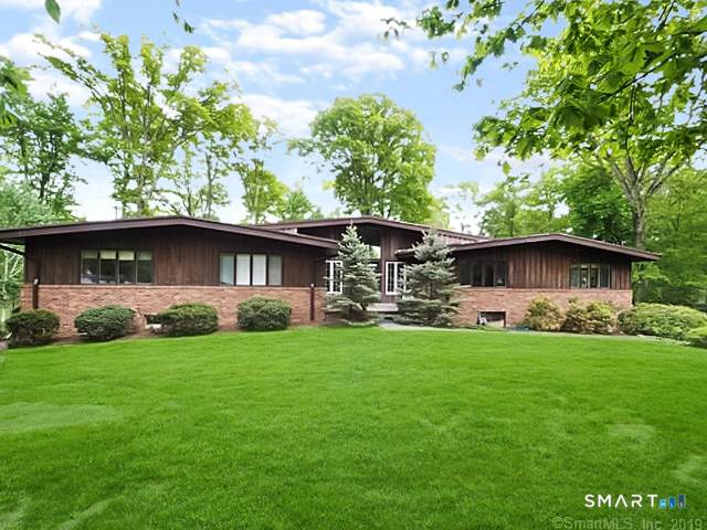 Stunning North Stamford California style ranch home on a secluded two acre wooded back lot.