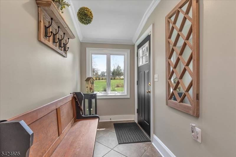 Set back from the road for added privacy, this expanded custom ranch sits on a lush one acre plus parcel in the heart of Millington.