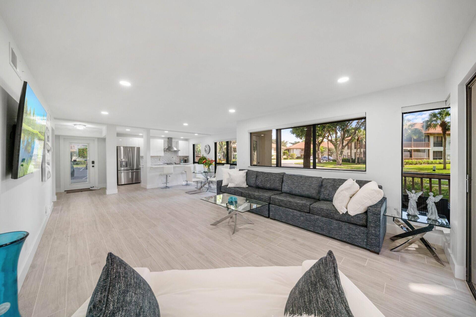 This stunning, fully remodeled two bedroom, two bath condo boasts a state of the art kitchen with quartz countertops, a large island with ample seating, and sleek stainless steel appliances.