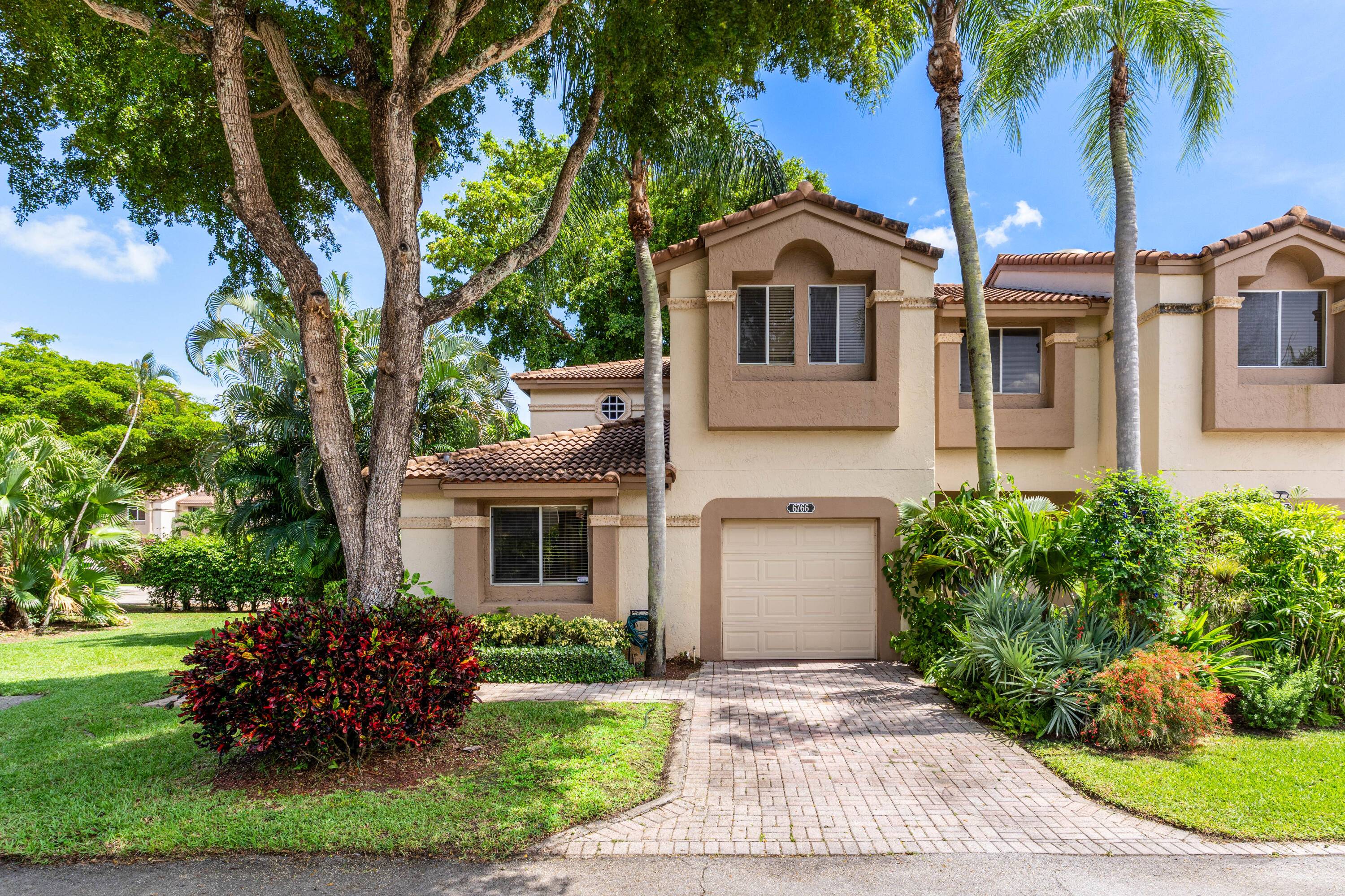 Welcome to this fully updated corner townhome located in the esteemed gated community of Boca Pointe.