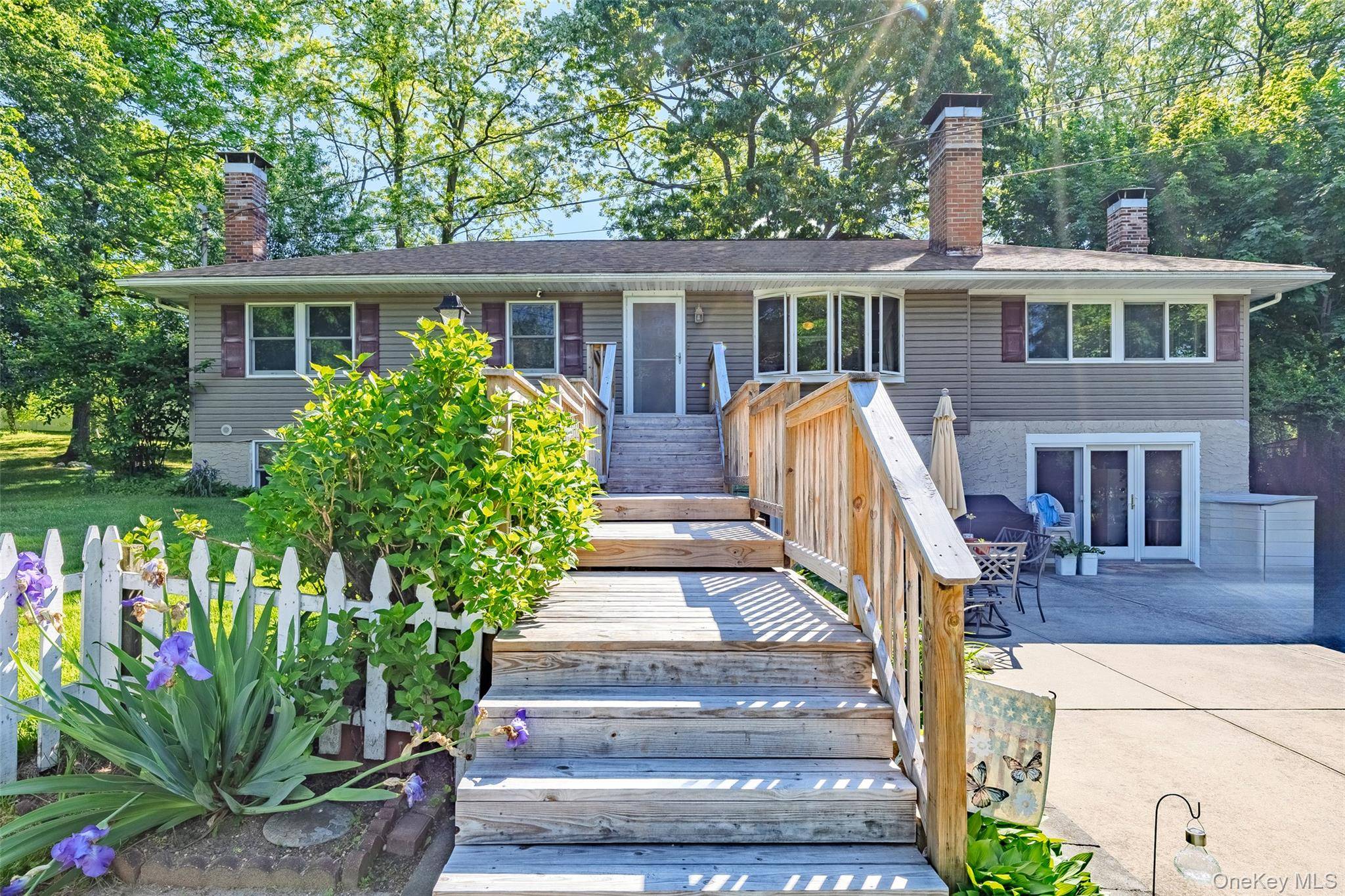 Charming 3 bedroom, 2 bath split level style home nestled on a spacious half acre lot in a desirable beachside POA community.