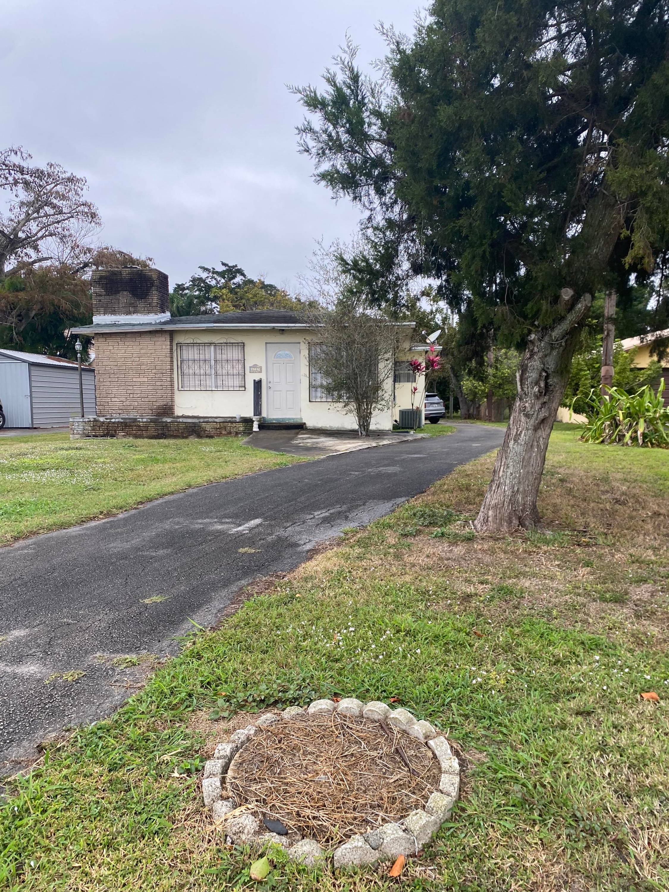 Charming home located in beautiful Pahokee directly across the street from Good Shepard School, lake behind it.