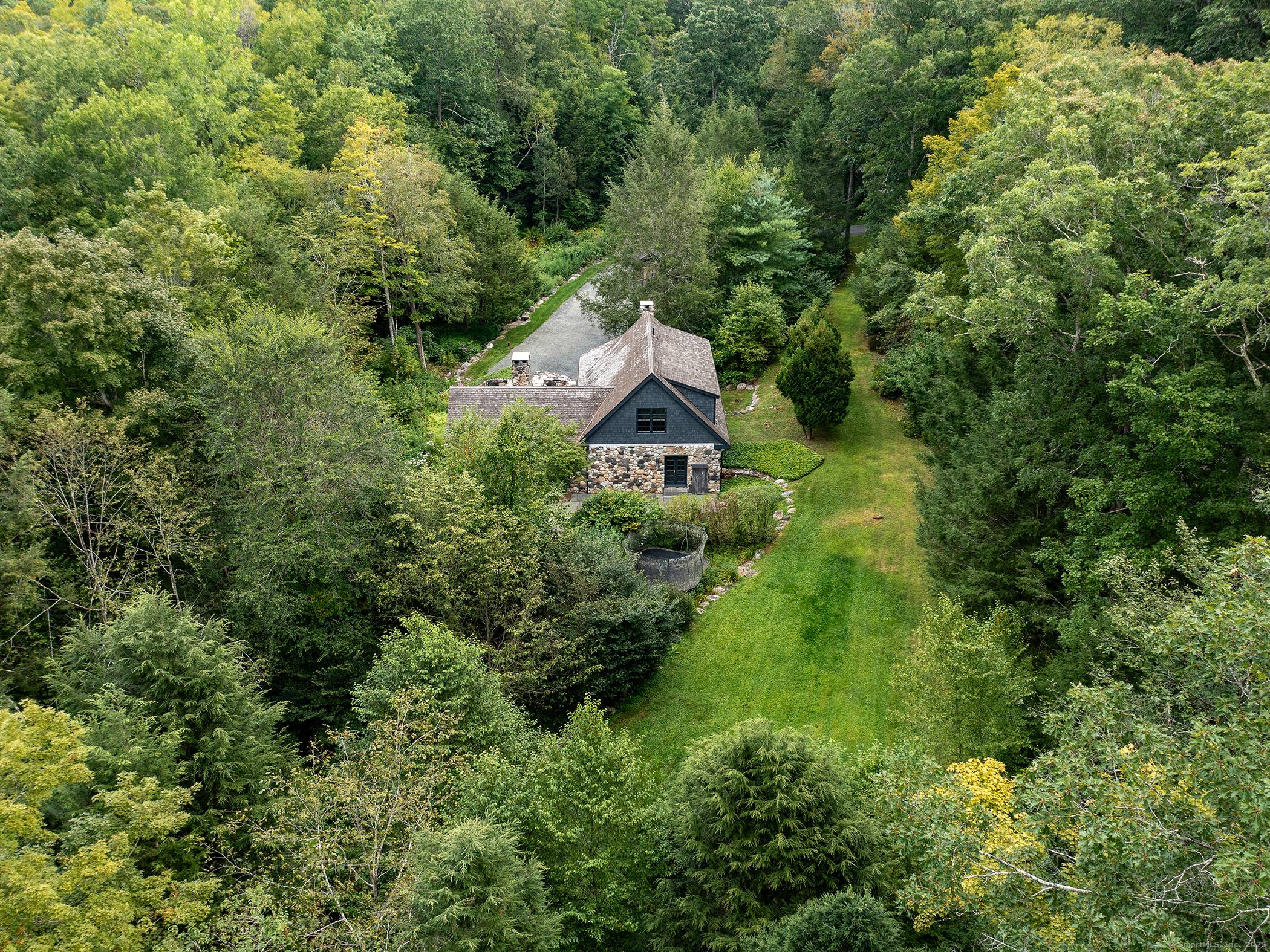 A Storybook Stone Cottage with 2000 feet of frontage along the Shepaug River.