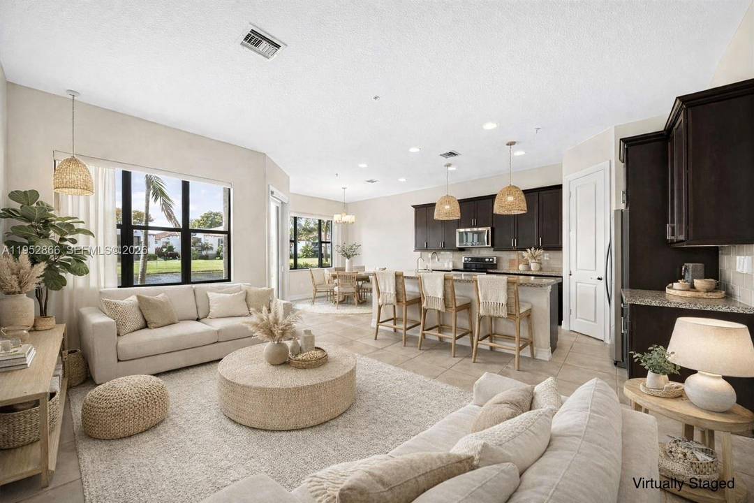 Exclusive move in ready, WATERFRONT, 2018 built LIKE NEW, 2, 133 sqft Townhome, with HIGH CEILINGS in the gated Raintree community with beautiful, lush landscaping !