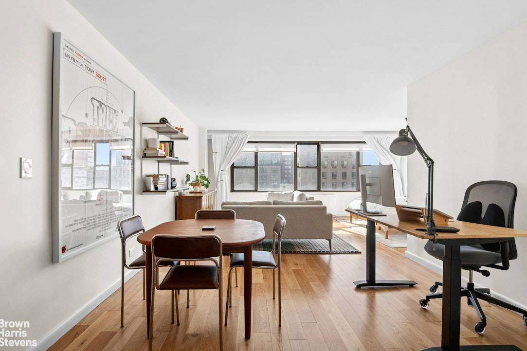 This beautifully gut renovated, oversized alcove studio is bathed in natural light from south facing windows, offering open views of the city's rooftops, buildings, and sky.