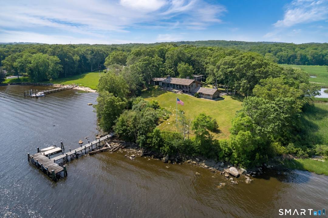 Discover one of the most coveted vantage points on the lower Connecticut River a mid century modern sanctuary perched on a private 2.