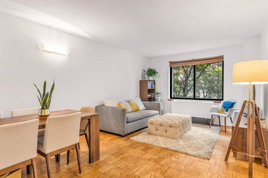 The expansive living dining area while the parquet flooring enhances the home s timeless appeal.