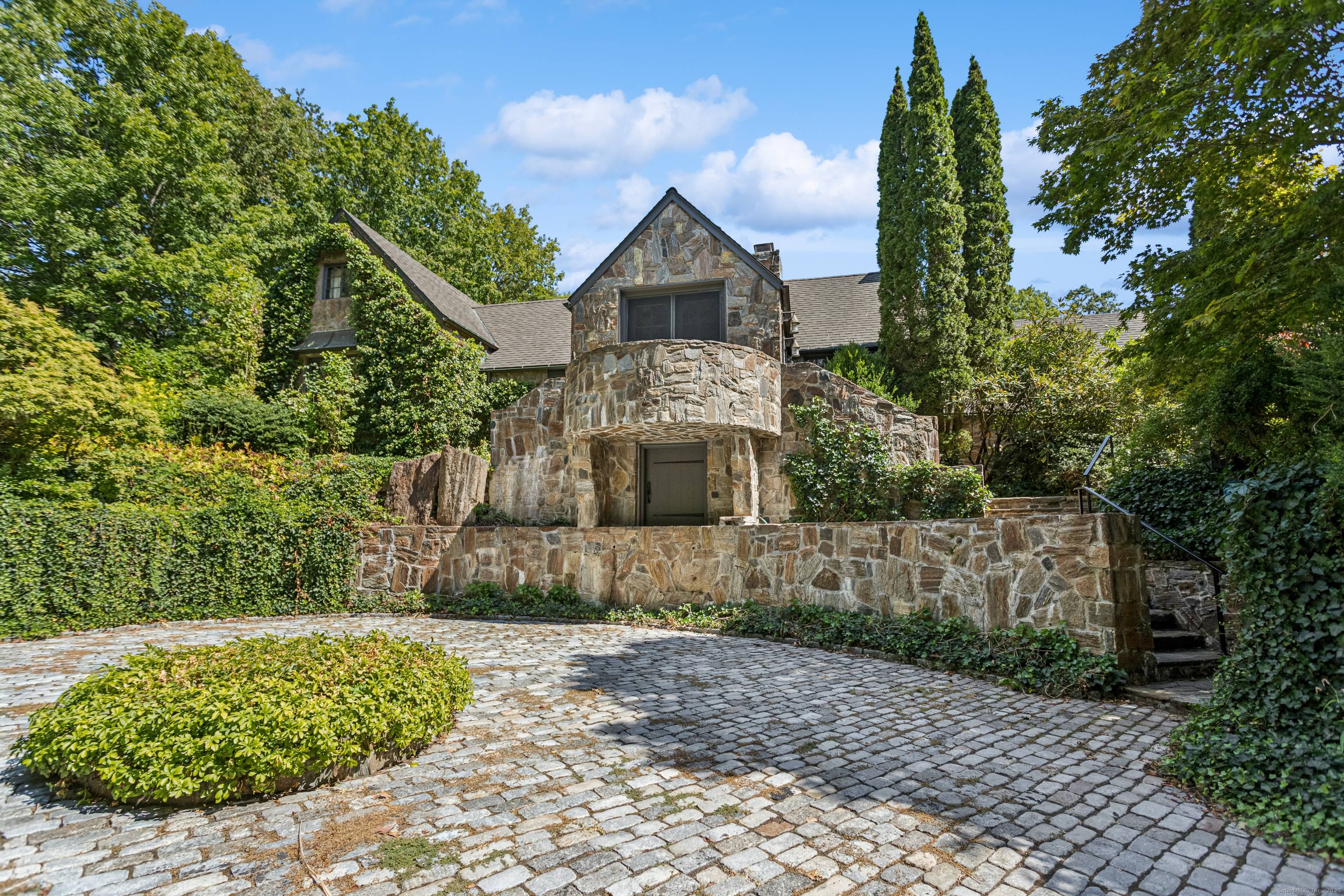 A rare offering, this remarkable Frazier Peters stone home is a masterful blend of historic character and timeless elegance, set impressively at the top of Charcoal Hill on 2.