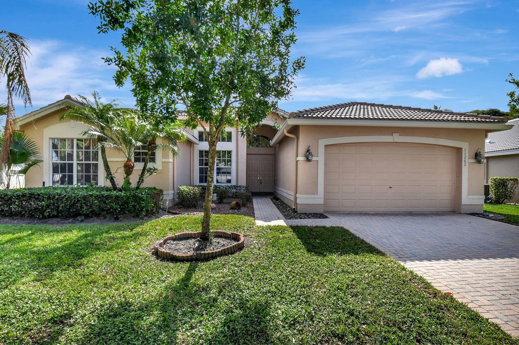 This stunning property boasts 3, 077 square feet of living space, featuring vaulted ceilings and picturesque views of a serene lake and garden.