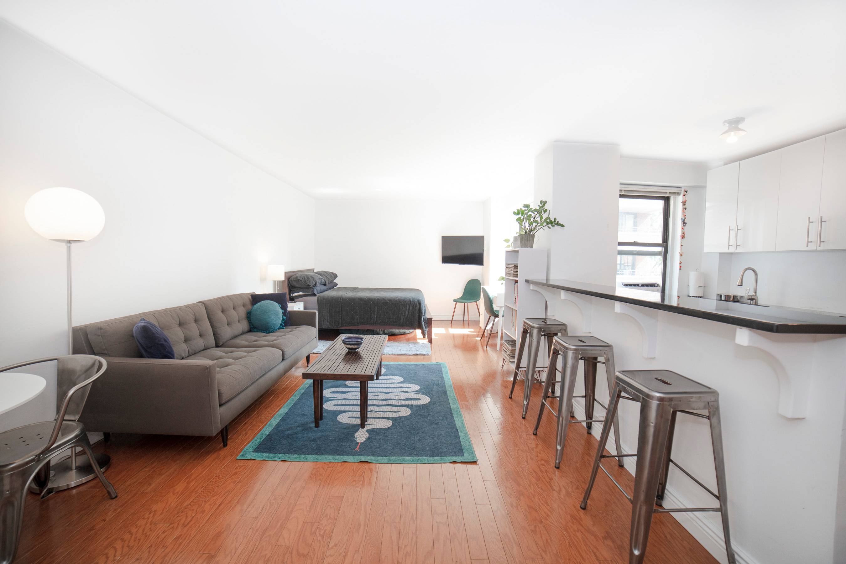 This loft like studio apartment is move in ready and features a large windowed kitchen complete with full size stainless steel appliances, extensive cabinet storage uppers and lowers, floor to ...