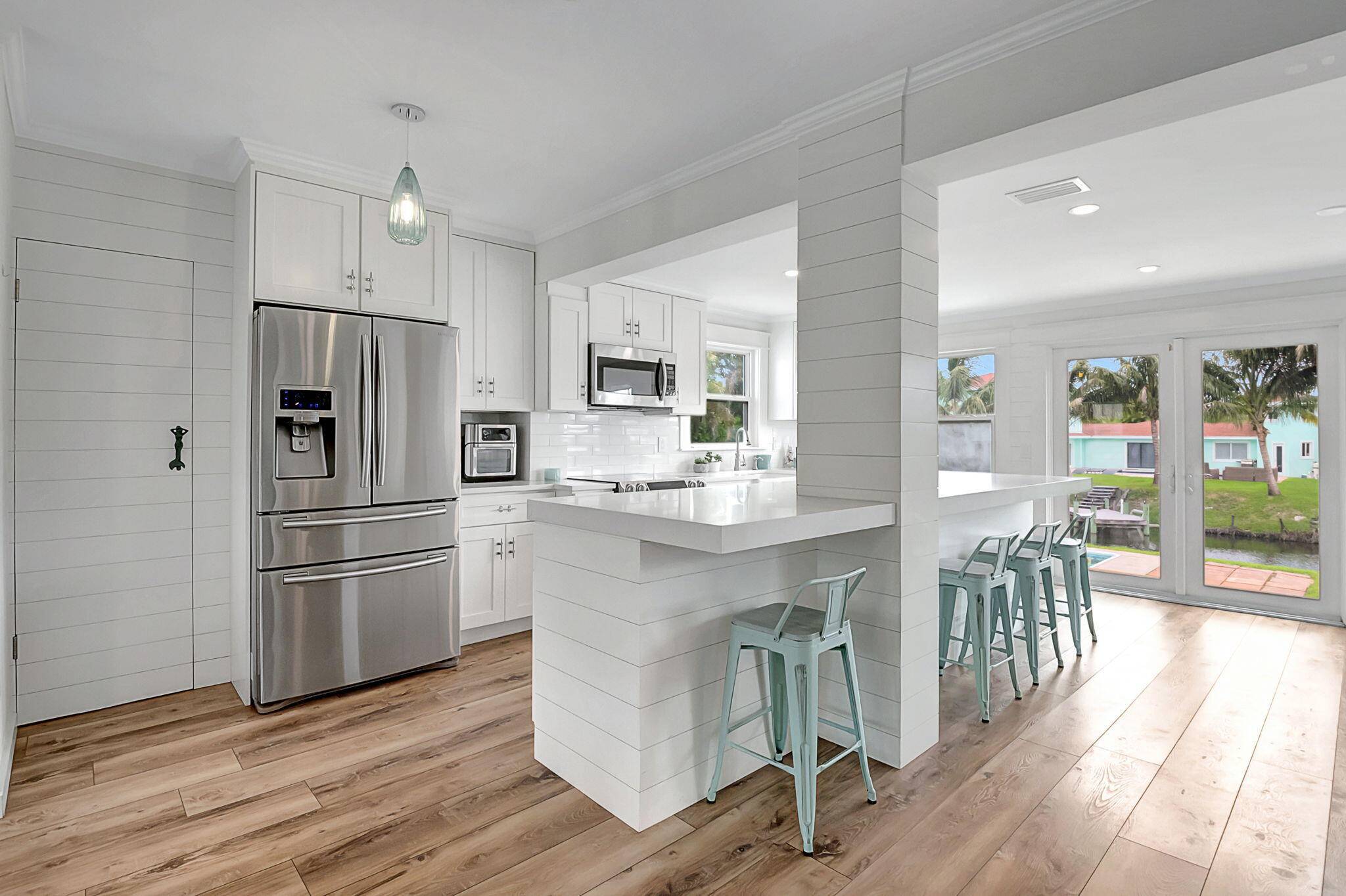 Explore this charming 3 bedroom, 2 bathroom home on a serene quarter acre lot in the desirable Chapel Hill neighborhood of Boynton Beach.